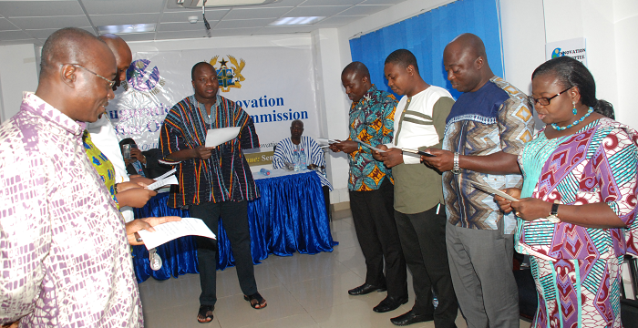  Mr Mahama Ayariga (middle), Minister for  Environment, Science, Technology and Innovation, swearing in the committee members